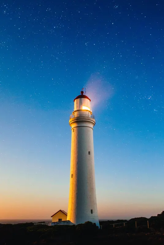 Photo of a lighthouse against a dusk sky